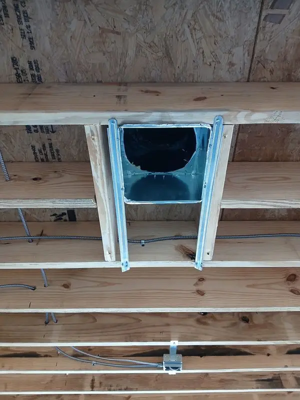 Bathroom exhaust fan roughed in between ceiling joists