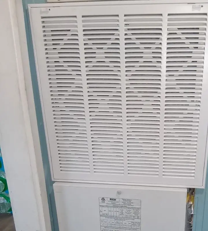 Return air grille fitted to an equipment closet door
