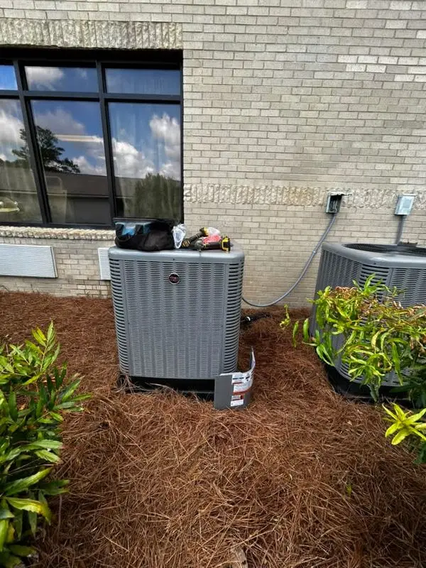 Condenser unit set on a pad beside a coastal Georgia home