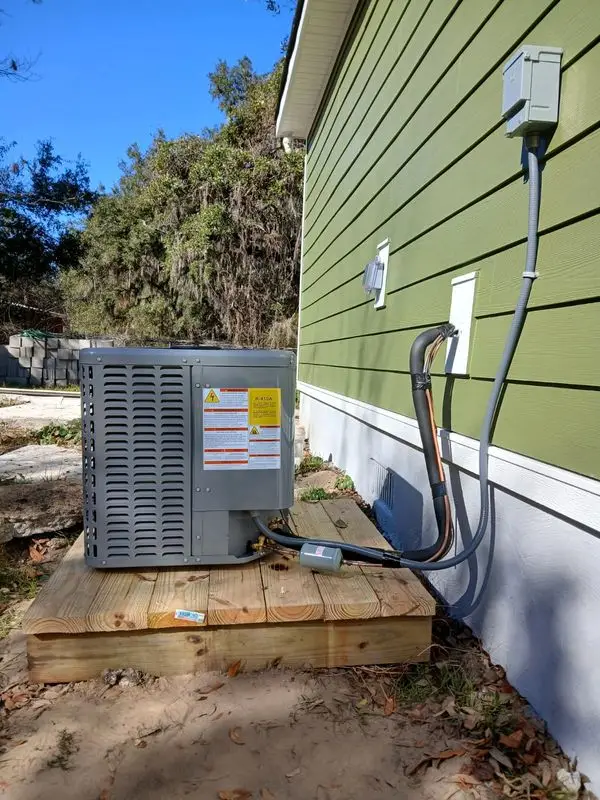 Condenser unit installed next to a wooden deck in Georgia