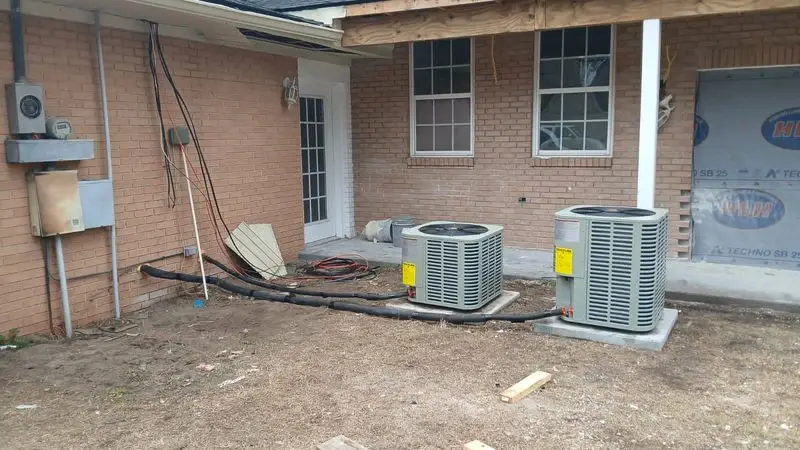 Pair of condensers installed behind a brick house in Georgia
