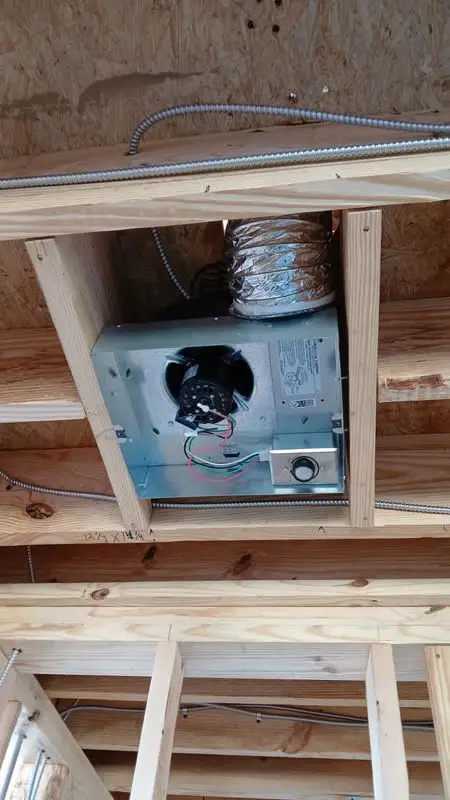 Exhaust fan with flex duct run installed in ceiling joists